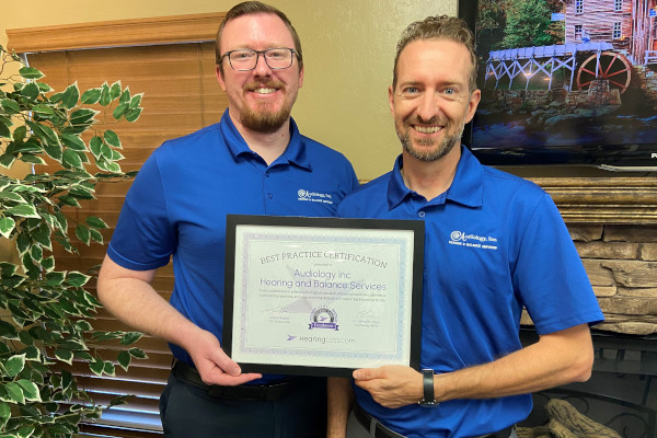Dr. Meyers & Dr. Cuff hold up their HearingLoss.com certification