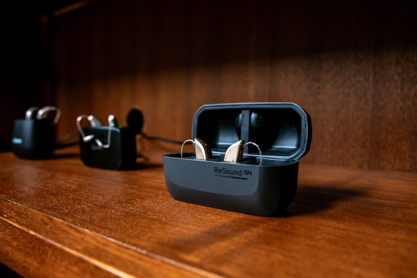 ReSound Hearing Aid Products displayed on a wooden shelf